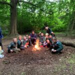 Cubs around a campfire